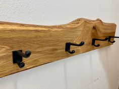 a wooden coat rack with hooks on it