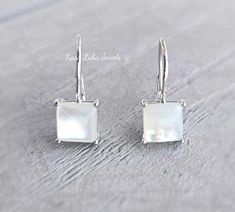 Mother of Pearl Dangle earrings - sterling silver - 925 - solid silver - pearls Height: 8.2mm Width: 8.0mm Thickness: 1.5mm Stone Material: Mother of Pearl Center Stone Size: 7.0mm Stone Shape: Square Stone Setting: Prong Metal: 925 Sterling Silver Finish: High Polish Nothing but the best from my custom jewelry store. If it doesnt fit, you have 30 days to return it or exchange it for another size. Email me if you have any questions. Formal Dangle Pearl Earrings In Mother Of Pearl, White Polished Finish Earrings, Formal Mother Of Pearl Dangle Earrings, Formal White Gold Mother Of Pearl Earrings, Hallmarked Sterling Silver Dangle Pearl Earrings, Sterling Silver White Gold Matching Pearl Earrings, Elegant Nickel-free Mother Of Pearl Jewelry, Minimalist Nickel-free Pearl Earrings For Formal Occasions, Minimalist Silver Mother Of Pearl Jewelry