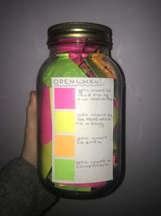 a jar filled with lots of different colored papers