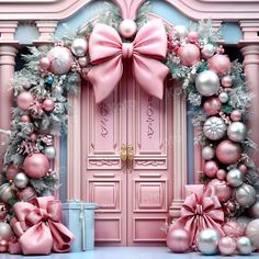 a pink door decorated with christmas ornaments and bows