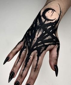 a woman's hand with black and white ink on it, holding a clock