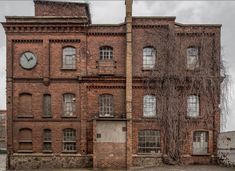 an old brick building with a clock on it