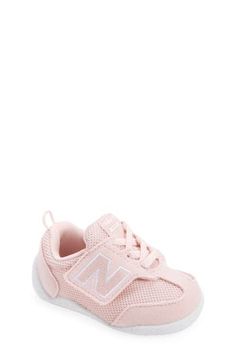 Baby's first steps will be supported in this sporty sneaker featuring a roomy toe box and easy-on/off strap. Adjustable hook-and-loop strap Removable insole Textile and leather upper/synthetic lining/rubber sole Imported Pink Slip-resistant Training Sneakers, Pink New Balance Synthetic Sneakers, Low-top Synthetic Sneakers With Soft Sole, Pink Slip-resistant Low-top Sneakers, Synthetic Sneakers With Soft Sole, Soft Sole Synthetic Sneakers, Synthetic Sneakers With Soft Sole, Closed Toe, Soft Sole Synthetic Closed Toe Sneakers, Pink Non-slip Low-top Walking Shoes