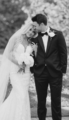 a bride and groom standing next to each other