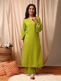 This green Kurta with Trousers set is made from a luxurious silk blend fabric, creating a stylish and comfortable outfit. The Kurta features a straight shape and round neck with flared three-quarter sleeves, while the Trousers have a partially elasticated waistband and slip-on closure for ease of wear. With a calf leng Western Kurtis, Comfortable Outfit, Eid Collection, Self Design, Comfortable Outfits, Salwar Kameez, Three Quarter Sleeves, Flared Sleeves, Quarter Sleeve