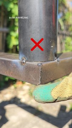 a close up of a metal object with a red x on it