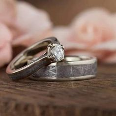 two wedding rings sitting on top of each other