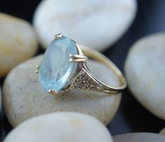 This is the perfect option for those who like cool, unique jewelry and the luxury, shine of yellow gold. This ring is well made, cute and/or elegant in design, and very desirable. Vintage ring decorated with the aquamarine like stone in the center and from the side is decorated with little diamonds . The 3 diamonds are missing. This ring stands out by itself or it is beautiful stacked with others rings. ♥ Age/era: 1980s - 1990s. ♥ The ring is a hallmark. 14K F.M. Franklin Mint. ♥ The ring's size Solid Gold Ring, Franklin Mint, Ring Light, Sterling Jewelry, Solid Gold Rings, Multi Stone Ring, Vintage Ring, Ring Vintage, Ring Ring