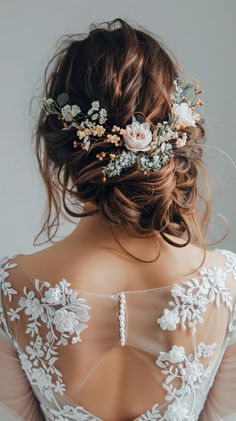 the back of a woman's head with flowers in her hair, wearing a wedding dress