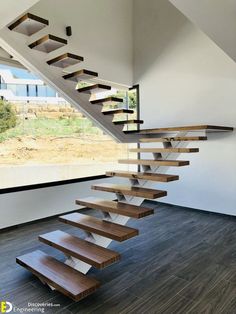 a wooden stair case next to a window