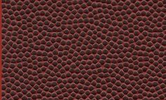 a close up view of a red surface with black dots