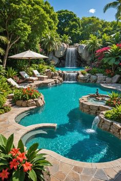 an outdoor swimming pool surrounded by tropical plants and flowers, with waterfall in the middle