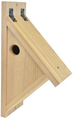 a wooden bird house with two holes in it