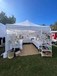 a white tent with tables and baskets under it