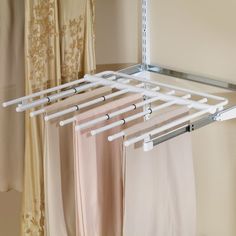 the clothes hangers are white and have four bars attached to them, along with two pairs of pants