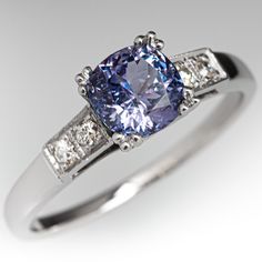 This alluring ring is centered with a no heat Tanzanian sapphire weighing 1.75 carats that we sourced and set in an elegant vintage platinum mounting. The shoulders of the ring are each accented with two (2), bead set, old European/single cut diamonds. The ring measures 7.0mm at the top, rises 7.2mm above the finger, tapering to 1.6mm wide and 1.2mm thick at the base of the shank. This ring is currently a size 9.75. Classic Sapphire Tanzanite Solitaire Ring, Classic Tanzanite Solitaire Sapphire Ring, Classic Purple Sapphire Ring With Prong Setting, Elegant Purple Sapphire Ring With Center Stone, Elegant Purple Platinum Rings, Elegant Purple Sapphire Solitaire Ring, Elegant Purple Solitaire Sapphire Ring, Classic Sapphire Rings In Purple, Purple Sapphire Ring With Brilliant Cut For Anniversary