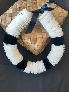 The pictured, handmade Hawaiian feather lei features black and white goose feathers.  Choose any color and/or pattern you like.  Made on Maui with love and aloha. Each feather is precisely measured, trimmed, and hand-secured into place on a central cordage core using 3 wraps and a half-hitch tie of thread. Satin ribbon secures the lei around the neck, hat, or head and is adjustable. Average length 23 inches long but you can choose any length you like. Length is start feather to end feather. The Mokihana Lei, Traditional Hawaiian Wedding Leis, Lei Po'o Flower Crowns, Puakenikeni Lei, White Goose, Heirloom Gifts, Feather Necklace, Goose Feathers, White Feather