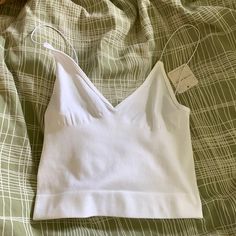 Free People White Cami Never Worn New With Tags White Stretch V-neck Camisole, Spring Tops With Built-in Bra For Relaxation, Low-cut Tops With Built-in Bra For Loungewear, White Seamless V-neck Top, Spring Low-cut Bra-friendly Top, Spring Relaxation Tops Bra Friendly, Spring Tops For Relaxation, Bra Friendly, White Seamless V-neck Crop Top, Relaxation Tops With Built-in Bra For Spring