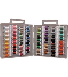 an open box with many different colored spools of thread in each one and the other