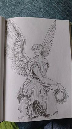 a drawing of an angel sitting on top of a book