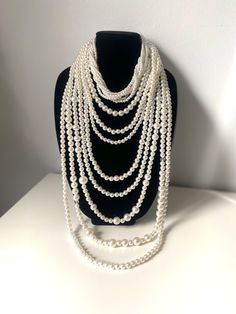 Stunning long multi-strand statement pearl necklace. Featuring a trendy layered chunky choker design. This cascade necklace showcases a beautiful waterfall of faux pearls in varying sizes, from delicate 2mm to bold 20mm. Perfect for adding a touch of elegance to any outfit, it's the ideal accessory for both casual and formal occasions. Make a statement with this eye-catching piece that effortlessly blends classic charm with modern flair. The necklace measures:  choker size 18" +4" (48 cm+10cm) Longest row : 46" (117 cm) Necklace drop: 23"(58cm) ----If you have any question please contact me---- I am inviting you to explore and enjoy my jewelry store; perhaps you will discover something unique for yourself or as a gift for someone special in your life. Thank you! https://www.etsy.com/shop/B Pearl Necklace Layered, Statement Pearl Necklace, Choker Design, Cascade Necklace, Chunky Choker, Choker Designs, Pearl Beaded Necklace, Pearl Statement Necklace, Necklace Layered