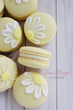 some yellow and white cookies with flowers on them