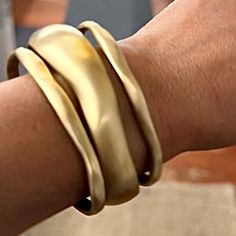 a close up of a person's arm with two bracelets on it