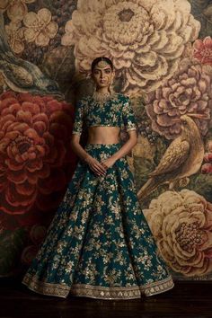 Teal Green Color Bridal Lehenga Choli from Sabyasachi Collection Brocade Lehenga With Gold Embroidery For Festivals, Anarkali Brocade Lehenga With Gold Embroidery, Green Raw Silk Lehenga With Meenakari, Green Meenakari Raw Silk Lehenga, Green Dupatta With Gold Embroidery For Wedding, Green Raw Silk Choli With Intricate Embroidery, Green Embroidered Raw Silk Lehenga, Embroidered Green Raw Silk Lehenga, Green Anarkali With Gold Embroidery