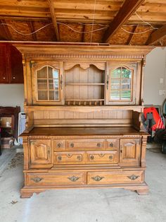 an old wooden dresser in a garage