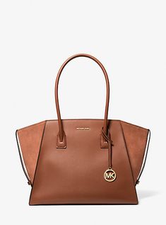 Equally versatile and sophisticated, our Avril tote is a must-have addition to your handbag lineup. Crafted from leather and suede, this gusseted design is rendered in a standout silhouette that’s generously sized to store a day’s worth of essentials. It’s the perfect complement to office-ready looks and casual weekend wear alike. Tote Bag Michael Kors, Suede Tote Bag, Bag Michael Kors, Large Leather Tote Bag, Suede Tote, Satchel Tote Bag, Large Leather Tote, Casual Weekend, Satchel Tote