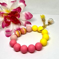 Add a pop of color and style to your keys with this vibrant and eye-catching handmade Bright Colorful Wristlet Bead Keychain! Made with pink & yellow silicone beads, this unique keychain doubles as a stylish accessory and makes it easy to grab your keys on the go. The perfect way to add a touch of fun to your everyday essentials or give as a thoughtful gift to a friend who loves bright and colorful accessories. Stay organized and stand out with this one-of-a-kind keychain. Trendy Pink Wristlet As Gift, Handmade Pink Bracelet For Everyday Use, Multicolor Wristlet With Lobster Clasp As Gift, Handmade Pink Bracelet For Everyday, Pink Wristlet With Lobster Clasp For Gifts, Trendy Wristlet With Keychain For Gift, Unique Keychains, Key Accessories, Colorful Accessories