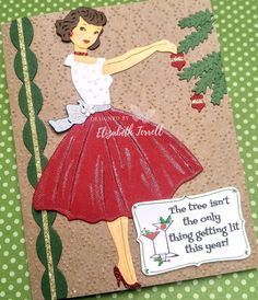 a handmade card with a woman in a red dress holding a christmas ornament