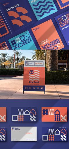 an array of different business cards on display in front of a building with palm trees