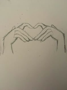 two hands holding each other in the shape of a heart