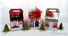 three small boxes with bows and decorations on them, one has a house in the middle