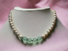 This pearl necklace, accented with jade beads, is a versatile piece. It's elegance is timeless.  A true statement piece and adds the perfect finishing touch to any outfit.  The necklace comes in 16 to 20 inches with a stainless steel lobster style clasp.  About the necklace:  Pearl size : 8 -9 mm Green jade nephrite : 10 mm Necklace length : 16 - 20 inches Closure : stainless steel lobster clasp Packaging : Soft silk bag Elegant Silver Jade Beaded Necklace, Elegant Jade Pearl Necklace For Gift, Silk Bag, Freshwater Pearl Necklace, Necklace Pearl, Jade Beads, Freshwater Pearl Necklaces, Green Jade, Pearl Size