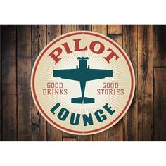 a sign that says pilot lounge with an airplane in the center on a wooden wall