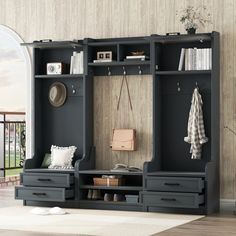 an entryway with a bench, coat rack and shoe storage unit in it's center