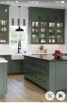 an image of a kitchen with green cabinets and white counter tops on the phone screen