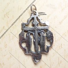 Size: 1 3/8 x 1 inch Material: Sterling silver This beautiful crucifix was cast in sterling silver from a mold made from an antique crucifix from Spain. It shows Christ on his cross between his blessed mother, the Virgin Mary, and the beloved disciple, St John. Surrounding this scene is a decorative framework of curling swirls. It looks delicate, but is quite sturdy. It's a unique and lovely representation of Christ's passion on the cross. The medal was cast in sterling silver from an antique me Spiritual Hallmarked Crucifix Jewelry And Charms, Spiritual Cross Jewelry For Commemoration, Silver Spiritual Crucifix Jewelry And Charms, Engraved Cross Pendant For Commemoration, Engraved Spiritual Cross Charms And Jewelry, Spiritual Silver Crucifix Jewelry And Charms, Engraved Spiritual Cross Jewelry And Charms, Difficult Children, Antique Silver Rings