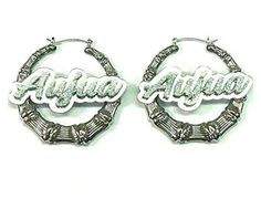 two hoop earrings with the word aluna on them