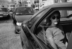 a woman sitting in the passenger seat of a car