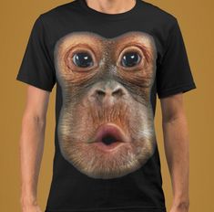 a man wearing a t - shirt with an image of a monkey's face