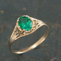 Oval Emerald Ring Filigree 14K Yellow Gold Ring 6 Prong Vintage Style Setting Antique Style Ring May Birthstone Ring Aurora Green Stone Ring To awaken from true loves first kiss, that is what we remember from Sleeping Beauty. Aurora was the princess' name. This beautiful ring emanates with Victorian style elegance and class. The delicate filigree encases the oval Emerald (quality your choice) which is held by 6 prongs. The stunning green stone measures 5mm by 7mm. The ring spans 7.5mm at the wid Yellow Gold Emerald Ring, Luxury Green Oval Engraved Ring, Emerald Gold Ring Vintage, Heirloom Style Solitaire Rings For May Birthstone, Victorian Yellow Gold Emerald Ring, Classic 14k Gold Rings With Accent Stones, Classic 14k Gold Filigree Ring With Gemstone, Classic Filigree Ring With Gemstone In 14k Gold, Classic Filigree Ring In 14k Gold With Gemstone