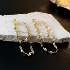 ✦ Make a bold style statement in your casual wear with our striking drop earrings featuring a daring geometric chain design, available in both glamorous gold and sleek silver options. Crafted for those who embrace edgy fashion, these earrings seamlessly blend modernity with boldness, ensuring you stand out with confidence. The dynamic geometric chain pattern adds an eye-catching element, making these earrings a versatile accessory for casual outings. The drop silhouette introduces a playful move Trendy Evening Jewelry With Adjustable Chain, Trendy Evening Jewelry With Chain Detail, Trendy Evening Jewelry With Chain, Gold Chain Metal Earrings For Party, Trendy Silver Linear Earrings, Gold Chain Earrings For Parties, Delicate Chain Drop Earrings For Party, Party Earrings With Gold Chain Detail, Party Earrings With Gold Chain