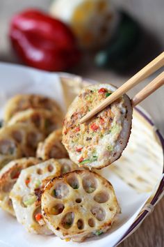 some food on a plate with chopsticks in it and the words lotus root stuffed renkon recipe