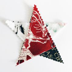 a red, white and black star shaped ornament sitting on top of a table