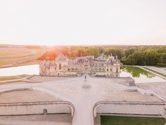 an aerial view of a large building with trees in the background