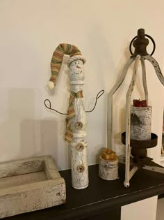 a wooden snowman sitting on top of a table next to other decorations and items