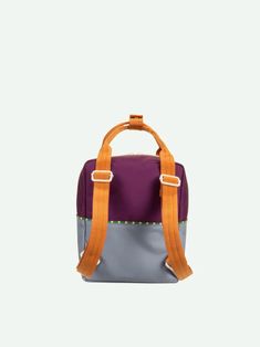 a small purple and grey bag with orange straps on it's handles, sitting against a white background